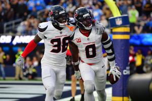 Dec 27, 2025; Inglewood, California, USA; Houston Texans linebacker Azeez al-Shaair (0) reacts with safety K'Von Wallace (38) after making an interception against the Los Angeles Chargers during the first half at SoFi Stadium. Mandatory Credit: Gary 