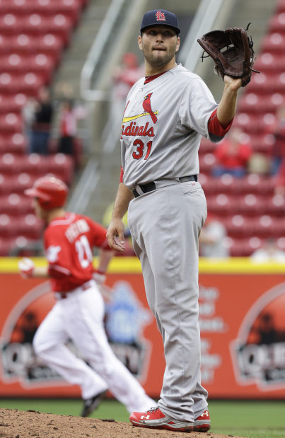 Cincinnati Reds' Todd Frazier (21) is congratulated by Zack Cozart (2)  after Frazier hit a solo home run off St. Louis Cardinals starting pitcher  Lance Lynn in the first inning of a