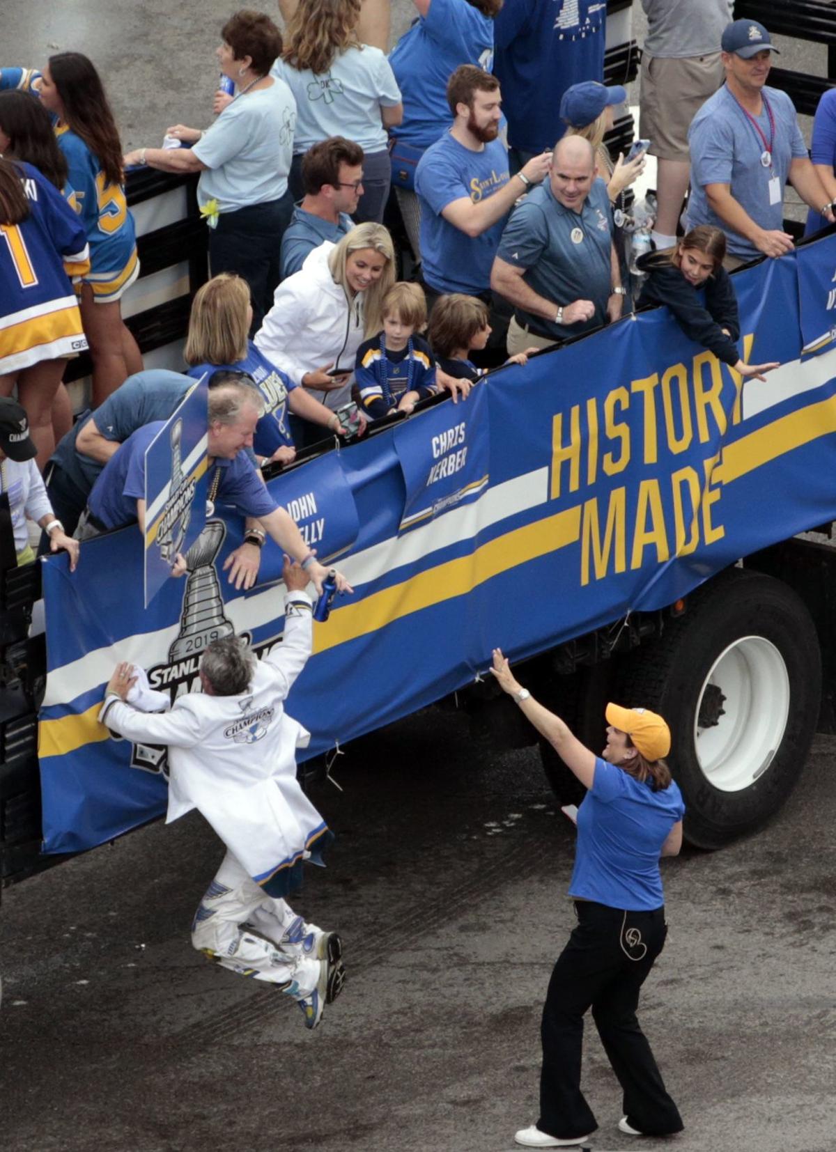 Pat Maroon stops and sets the Stanley Cup on a St. Louis Rams blanket that  a fan laid down for the parade to drive over : r/stlouisblues