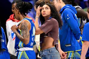 Dallas Wings guard Azzi Fudd looks on from the team bench.