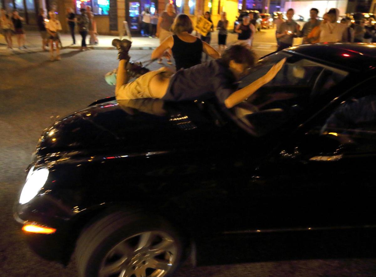 Car drives through protesters in St. Louis