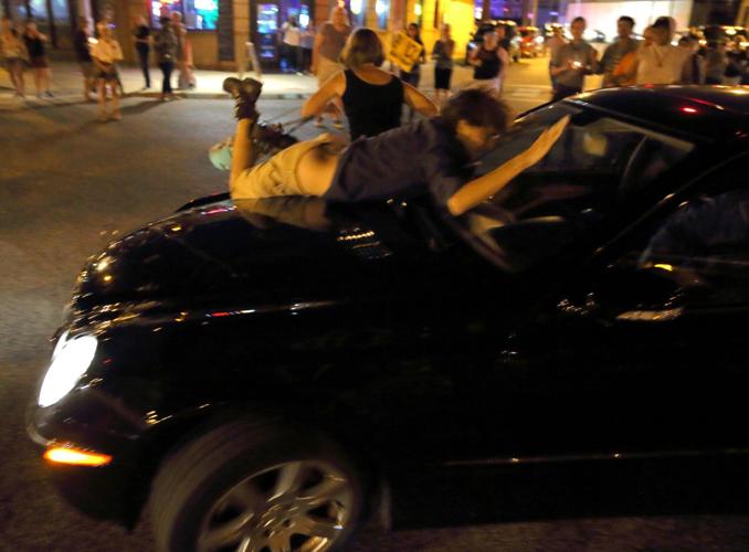 Car drives through protesters in St. Louis