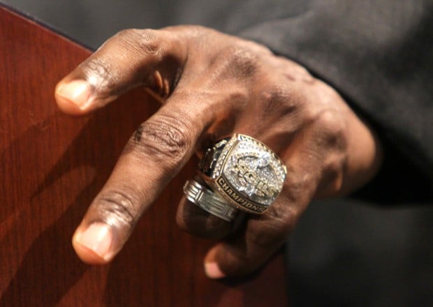 St. Louis Rams wide receiver Isaac Bruce holds one of his jerseys after  offically retiring from the National Football League at the team  headquarters in Earth City, Missouri on June 9, 2010.