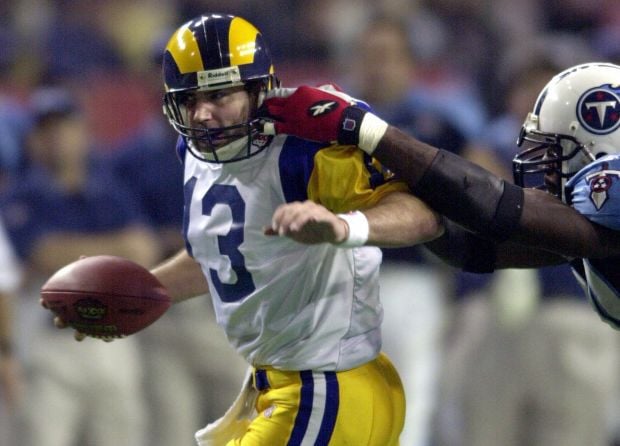 Former St. Louis Rams Isaac Bruce holds the Super Bowl trophy during  ceremonies celebrating the teams Super Bowl victory in the 1999-2000  season, at the Edward Jones Dome during half time of