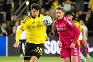 St. Louis CITY SC midfielder Tyson Pearce (33) chases down a ball in front of St. Louis CITY SC defender Lukas MacNaughton (5)