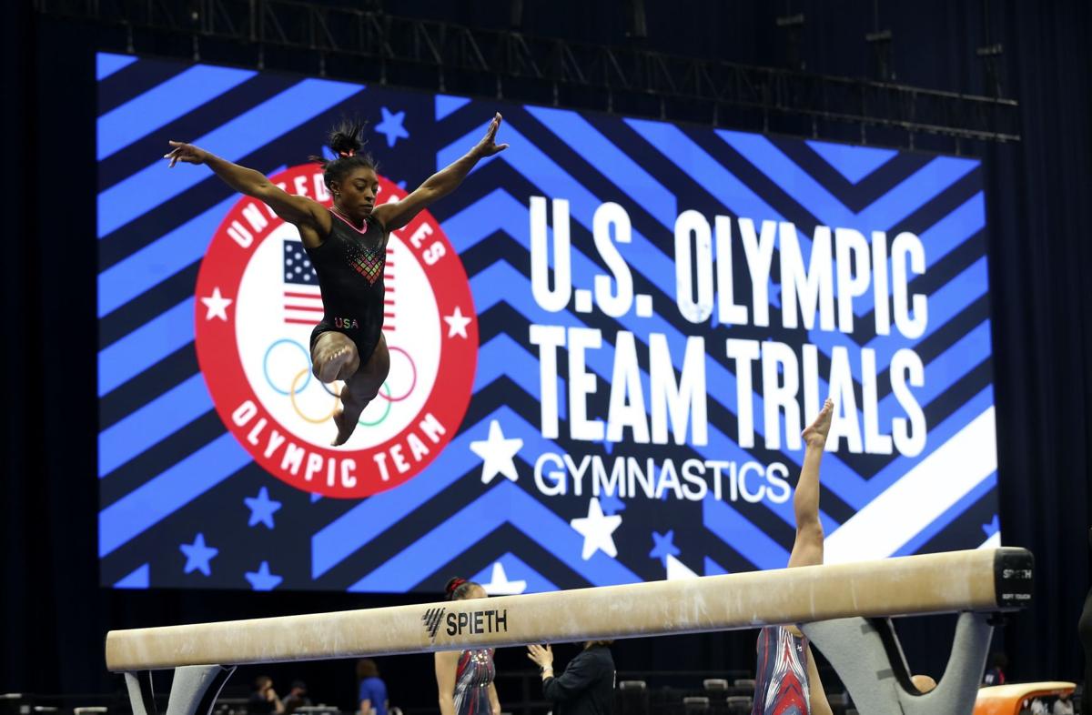 Reigning all-around champion Simone Biles practices on the ...