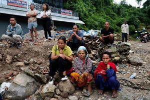 Around the world, people desperately search for news of missing loved ones after Nepal-China floods