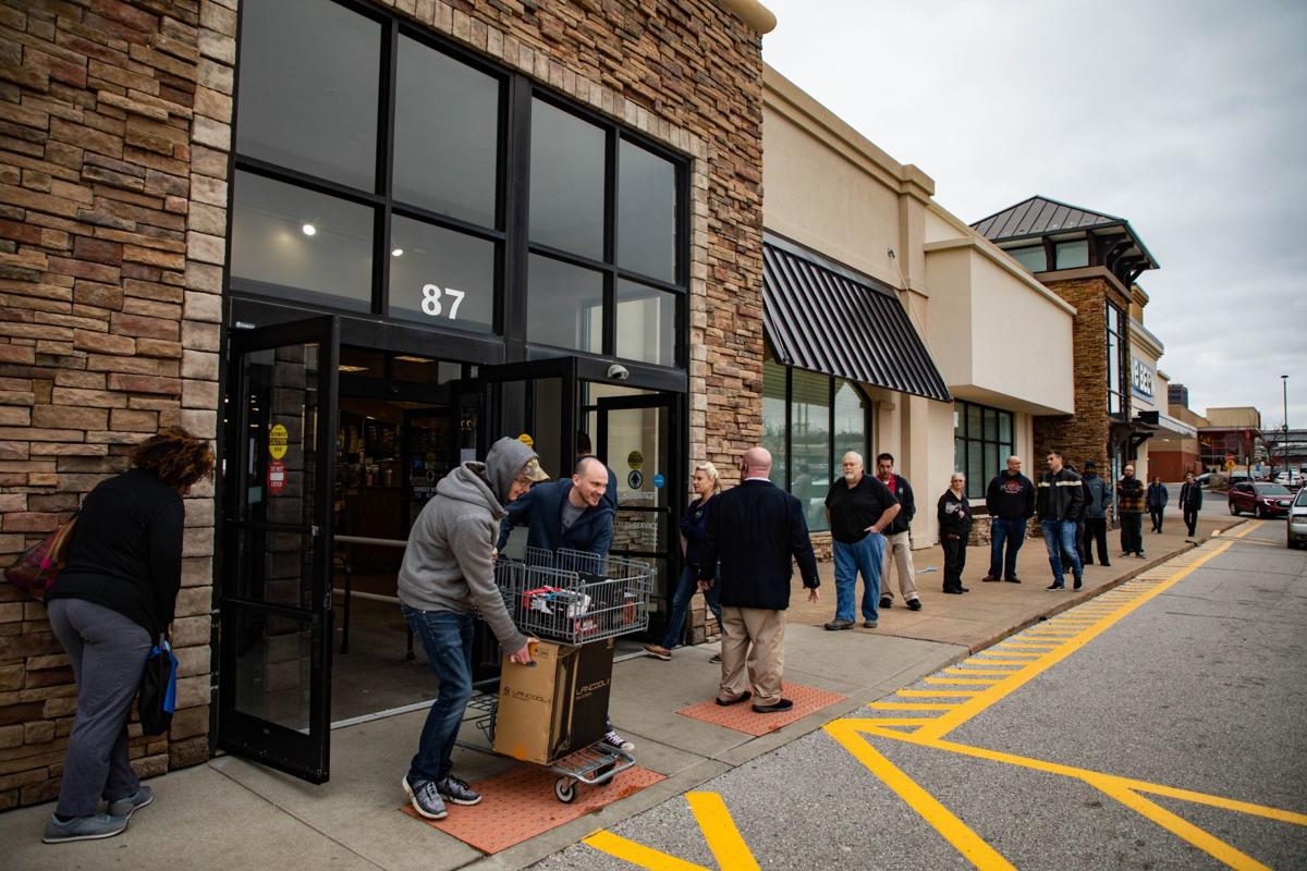 Lines form outside computer stores as people prepare to work from home during coronavirus outbreak