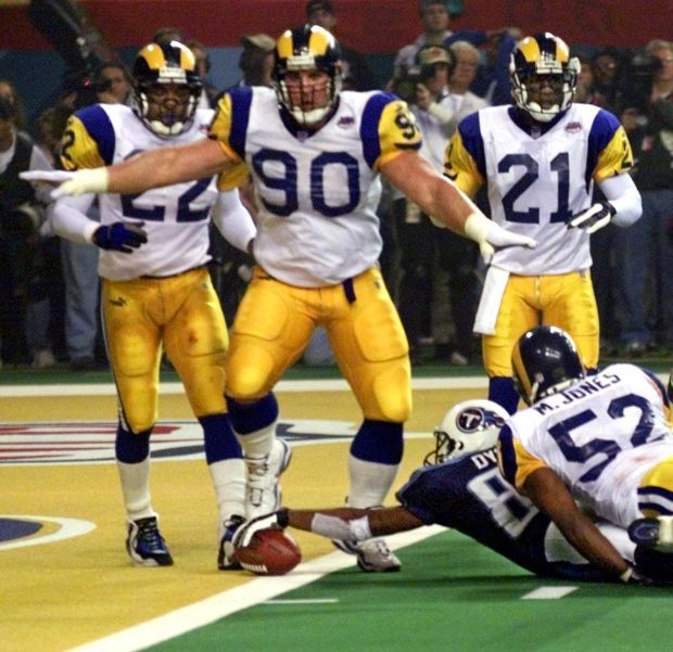 Former St. Louis Rams Isaac Bruce holds the Super Bowl trophy during  ceremonies celebrating the teams Super Bowl victory in the 1999-2000  season, at the Edward Jones Dome during half time of