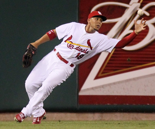 Jon Jay of the St. Louis Cardinals, left, celebrates with teammate Daniel  Descalso after scoring in the seventh inning against the Washington  Nationals in Game 3 of their National League Division Series