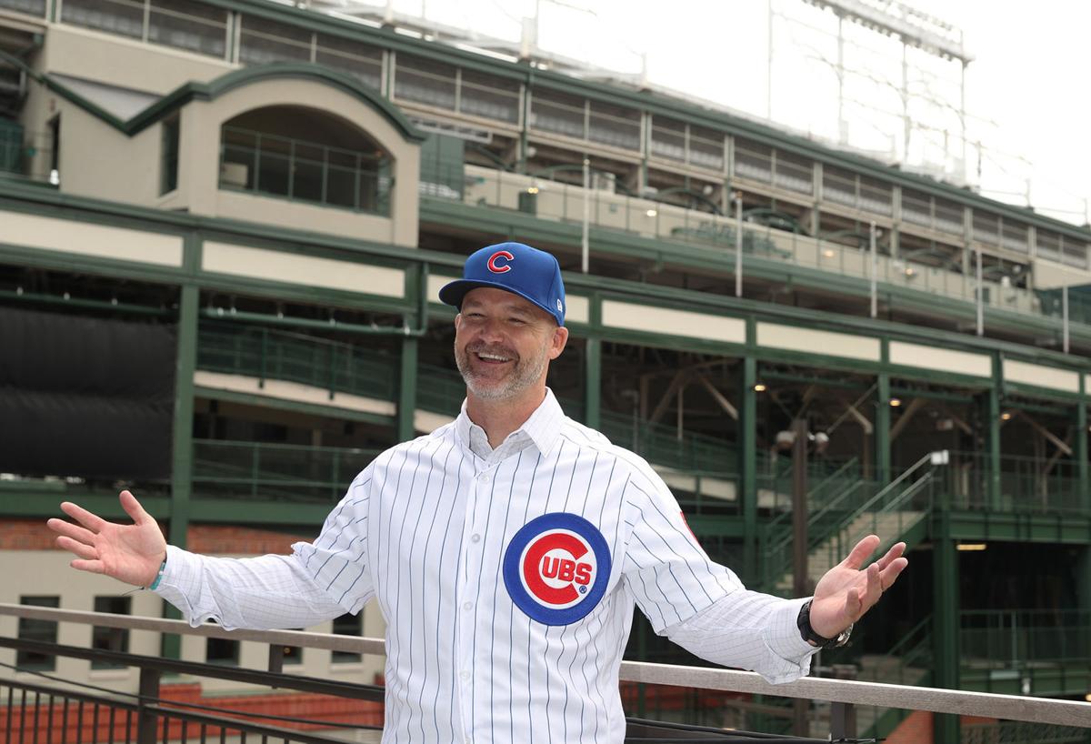 New Cubs manager David Ross poses for photographs at the American Airlines Conference Center next to Wrigley Field.