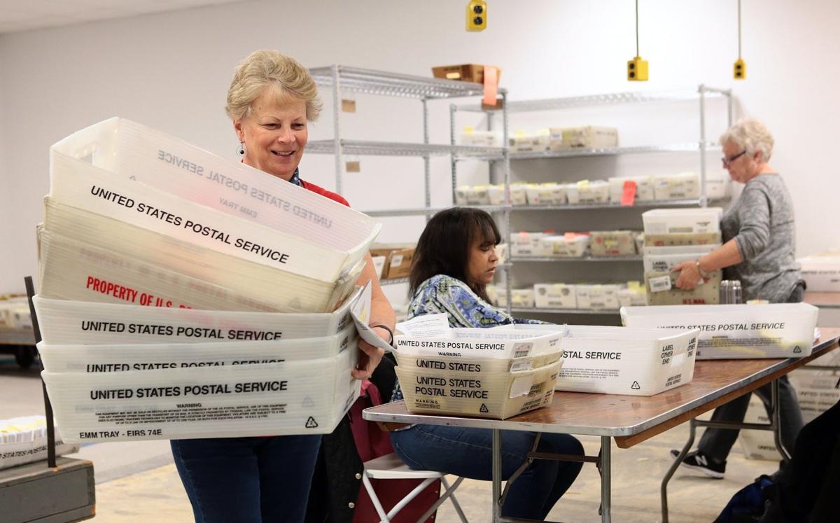 Tallying absentee votes at the St. Louis County Board of Election