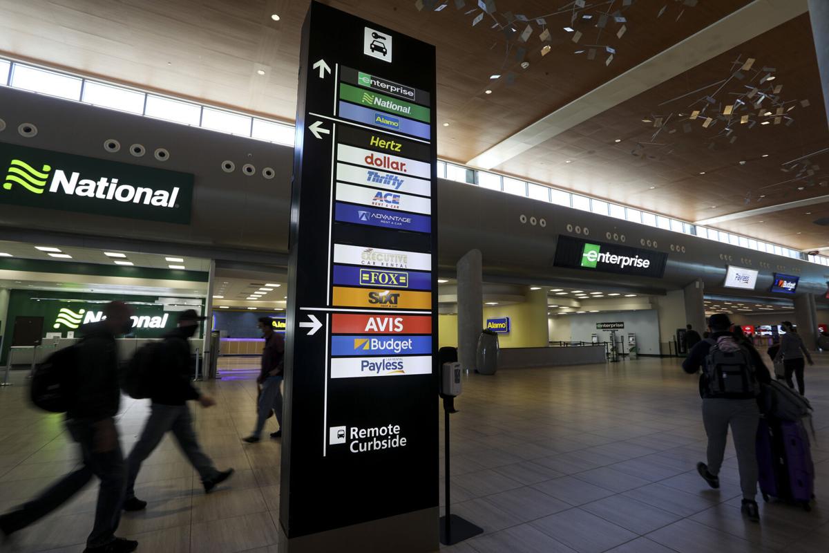 Travelers walk inside Tampa International Airport's Rental Car Center in Tampa, Florida, on March 19, 2021.
