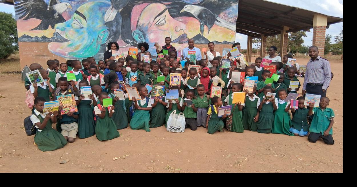 Social work advisor Tchule Moore brings books to Malawi students
