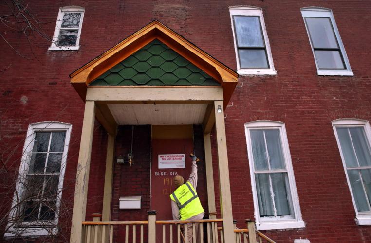 Police officers team with city code enforcers to stabilize vacant buildings