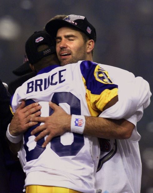 JANUARY 30 2000: Rams quarterback Kurt Warner (13) tries to avoid Titans  defense end Jevon Kearse as the St. Louis Rams defeated the Tennessee  Titans 23-17 to win Super Bowl XXXIV at