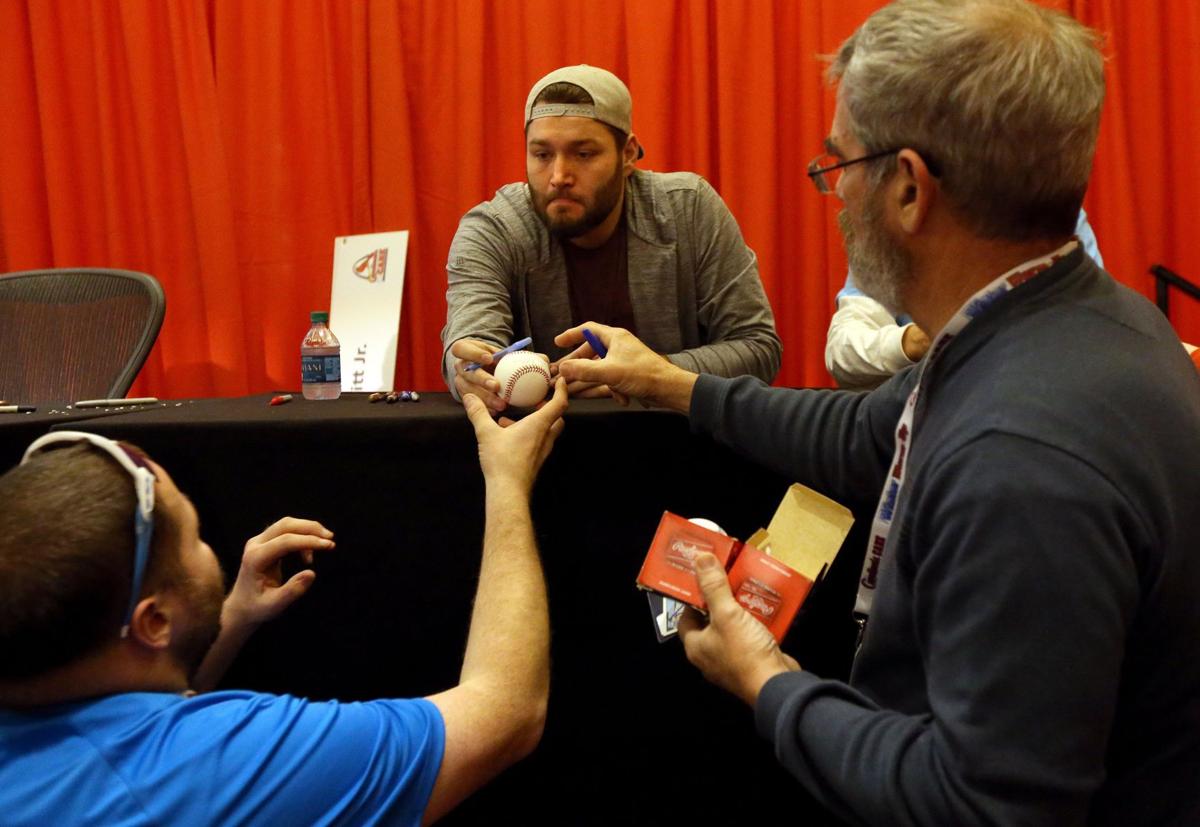 Lance Lynn signs a baseball during Cardinals Winter Warm-up