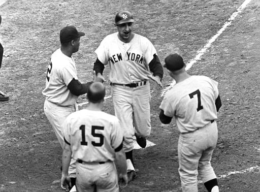 Yankee manager Yogi Berra (8) signals the bullpen for a new hurler after  Whitey Ford, hand on hips, has been rocked for a two-run homer by the  Cardinals in sixth inning of