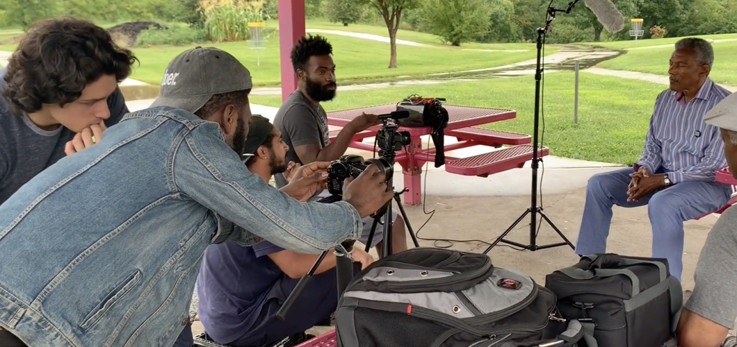 Damien Smith (center) in screen shot from documentary.png