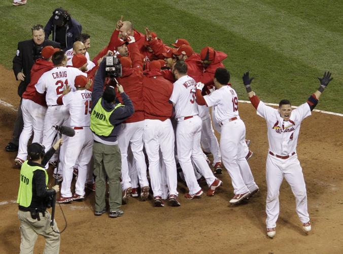 St. Louis Cardinals David Freese is mobbed by teammates including