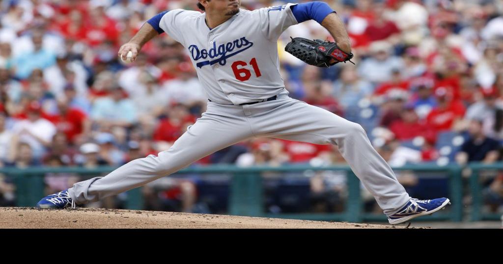 Los Angeles Dodgers left fielder Manny Ramirez tosses his glove