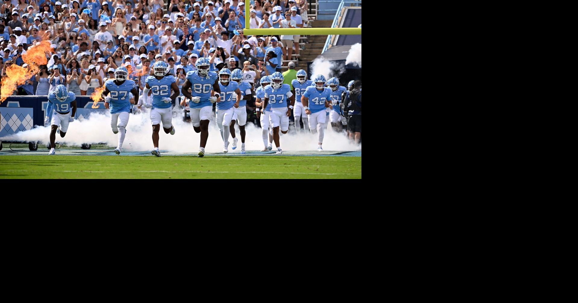 Sep 13, 2025; Chapel Hill, North Carolina, USA; North Carolina Tar Heels run on to the field before the game at Kenan Stadium. Mandatory Credit: Bob Donnan-Imagn Images