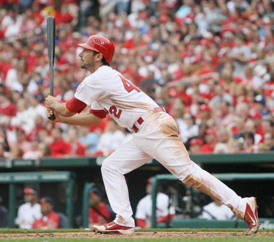 St. Louis Cardinals' Matt Carpenter wears camouflage socks as part of his  Memorial Day uniform as he fouls a ball off his leg while batting during  the first inning of a baseball