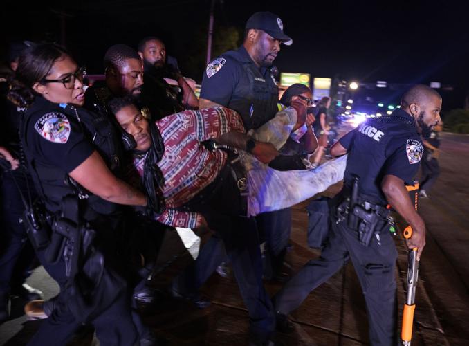 Protesters reunite outside the Ferguson police department on 10th anniversary