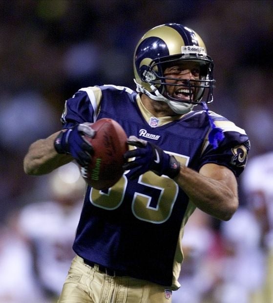 St. Louis Rams' Aeneas Williams, holds his son, Lazarus, as he celebrates  the Rams' 29-24 victory over the Philadelphia Eagles in the NFC Championship  game Sunday, Jan. 27, 2002 in St. Louis. (