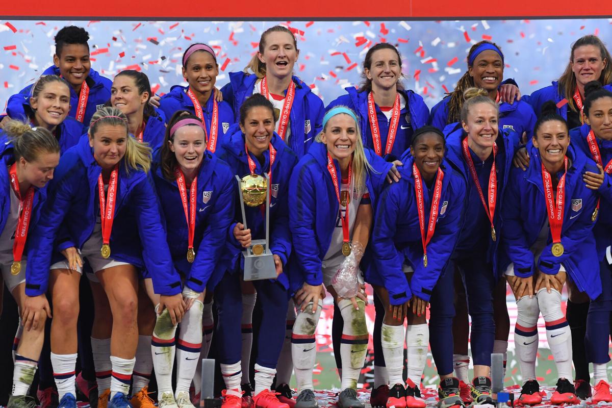 Carli Lloyd, middle, and fellow United States teammates celebrate after defeating Canada, 3-0, in the CONCACAF Women's Olympic Qualifying Final at Dignity Health Sports Park on February 9, 2020, in Carson, California.