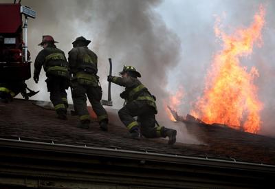Fire burns through roof of vacant rowhouse apartments