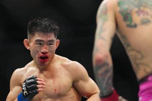 Jan 24, 2026; Las Vegas, Nevada, USA; Sean O’Malley (red gloves) fights Song Yadong (blue gloves) during UFC 324 at T-Mobile Arena. Mandatory Credit: Stephen R. Sylvanie-Imagn Images