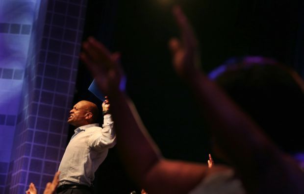 St. Louis Rams' Aeneas Williams, holds his son, Lazarus, as he