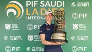 Charley Hull of England poses with her trophy at the PIF Saudi Ladies International