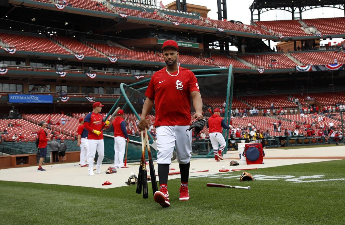 Former St. Louis Cardinals slugger Mark McGwire waves to fans as he is  driven around the track before a game against the Pittsburgh Pirates on  Opening Day in St. Louis on Thursday