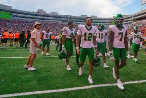 Oregon players walk off the field as fans storm the field as the Oregon Ducks face the Oklahoma State Cowboys on Sept. 12, 2026, at Boone Pickens Stadium in Stillwater, Oklahoma.