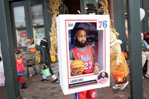Early trick-or-treaters seek Halloween treats on Main Street
