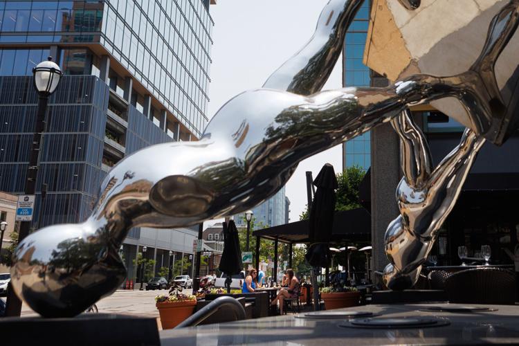 Dining near sculptures in downtown Clayton