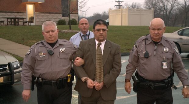 Russell Faria is led away after being convicted of his wife's murder.