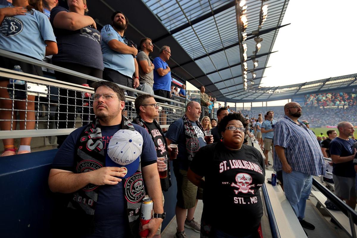 ST. LOUIS, MO - MAY 20: A fan holds up a scarf towards the Sporting Kansas  City players saying that St. Louis is America's first soccer capital during  a game between Sporting