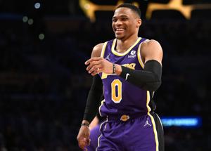 Feb 16, 2022; Los Angeles, California, USA; Los Angeles Lakers guard Russell Westbrook (0) laughs at a play by Utah Jazz guard Donovan Mitchell (not pictured) in the first half at Crypto.com Arena. Mandatory Credit: Jayne Kamin-Oncea-USA TODAY Sports