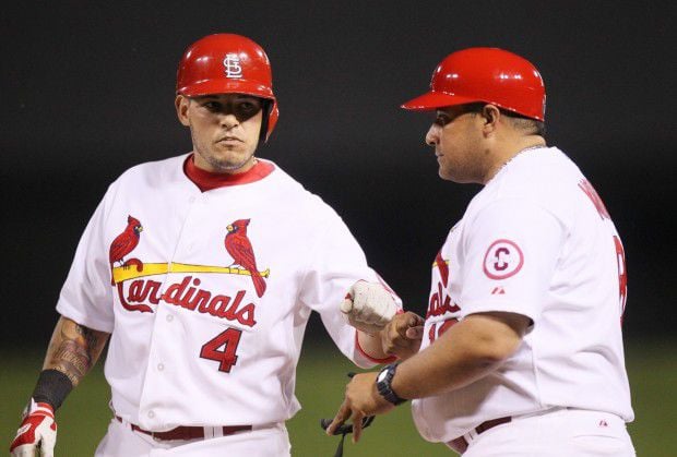 St. Louis Cardinals Yadier Molina is restrained by brother Bengie