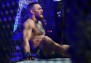 Conor McGregor reacts following an injury suffered against Dustin Poirier during UFC 264 at T-Mobile Arena.