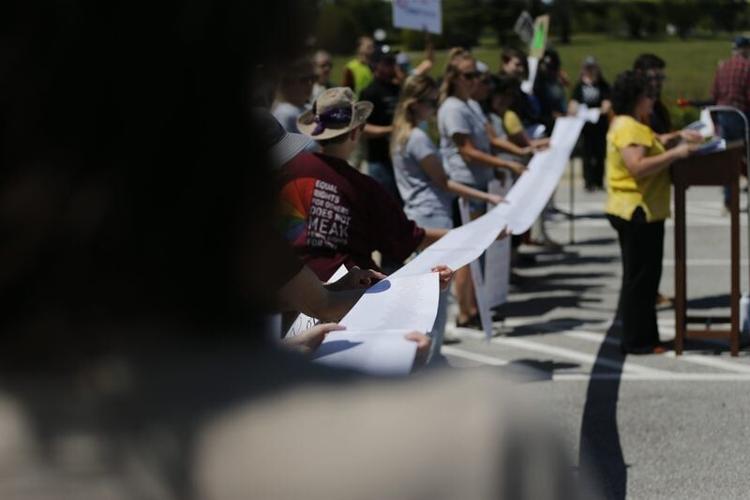 A scroll containing more than 3,000 names of people who have been held at Greene County Jail for ICE since June 2025 is unraveled during an Immigrant Justice Collaborative news conference outside of the Greene County Jail on Saturday, April 25, 2026.
