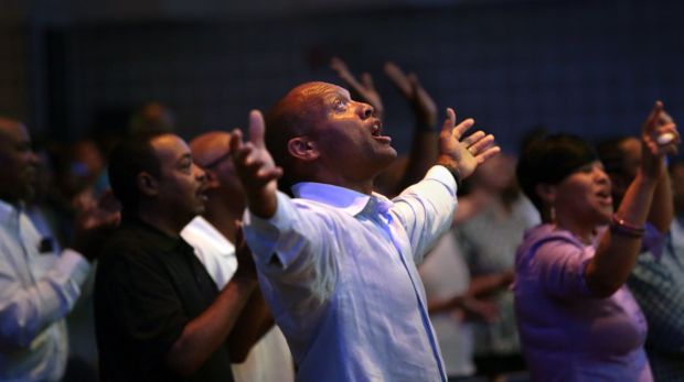 St. Louis Rams' Aeneas Williams, holds his son, Lazarus, as he