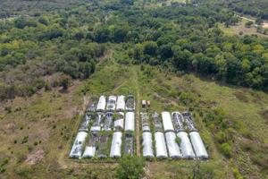 Grow houses are lined up in various states of disrepair at the site of a former marijuana grow in Holdenville.