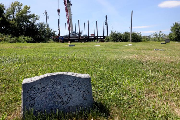 Billboards that towered over Washington Park Cemetery are coming down