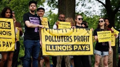 People attend a “Make Polluters Pay” rally