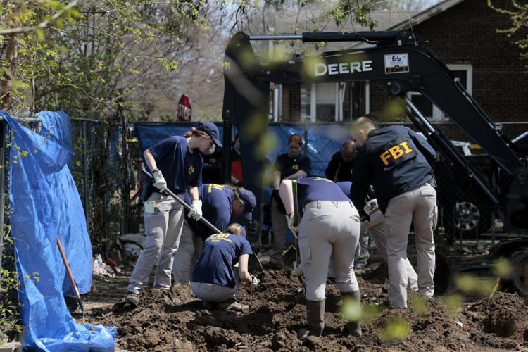FBI crew digs in the yard at a home in Dutchtown