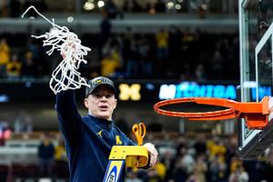 Michigan coach Dusty May celebrates after winning the NCAA Tournament Midwest Regional final by defeating Tennessee 95-62 at